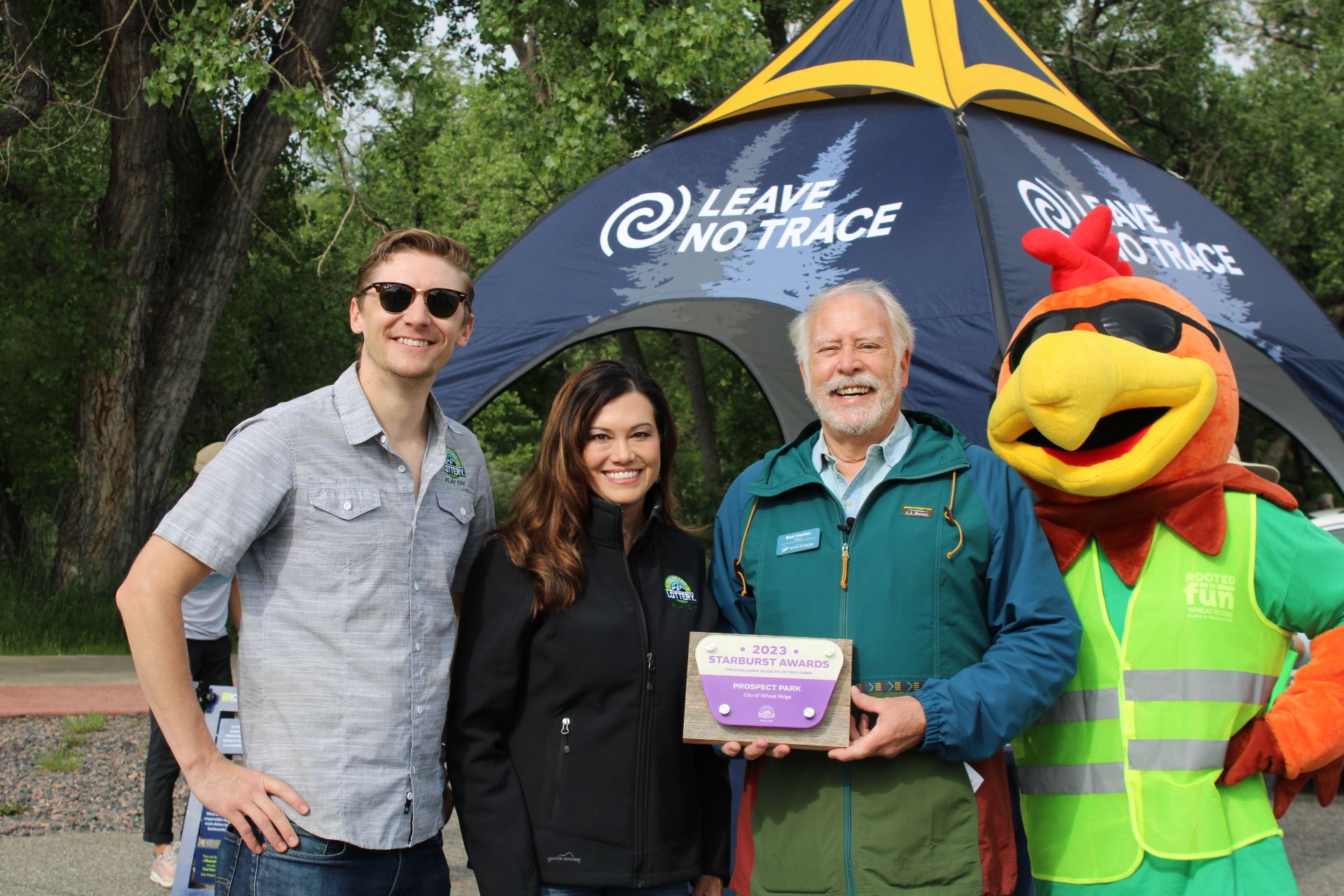 Mayor Starker, Booster the Rooster, and Colorado Lottery Staff with Starburst Award Plaque